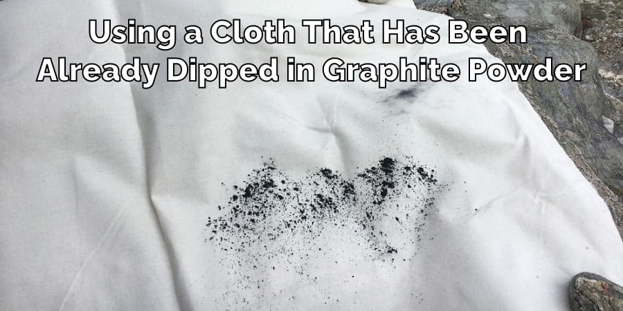 Using a Cloth That Has Been Already Dipped in Graphite Powder